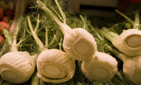 Fresh green and white leeks in a vegetable marketの写真素材