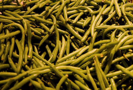 Fresh whole long green beans in a vegetable market