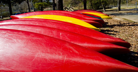 Closeup of a row of red and yellow kayaks or canoesの写真素材