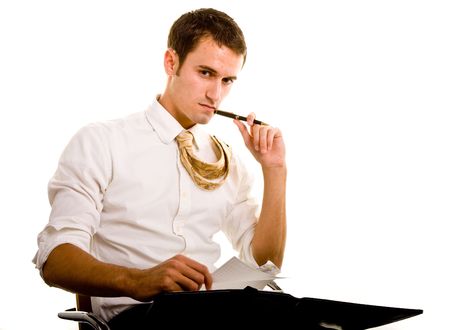 A nice looking young man sitting in a chair with a notebook, with his tie over his shoulder の写真素材
