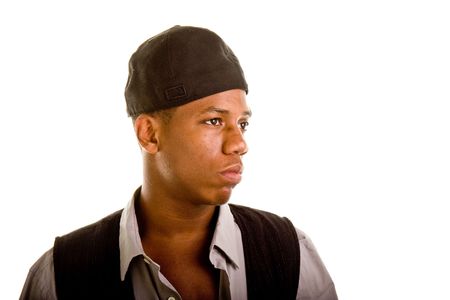 Young black man dressed casually wearing a cap sideways and looking off to leftの写真素材