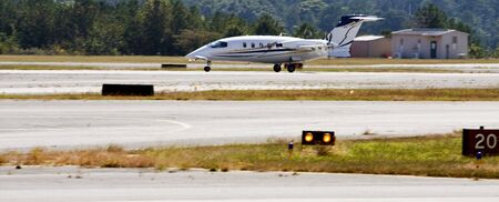 A turbo prop plane landing on a runwayの写真素材