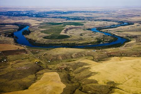 A horseshoe shaped curve in a large river from aboveの写真素材
