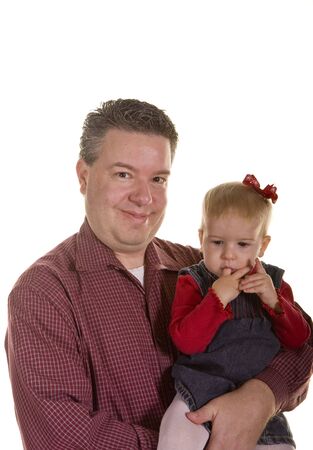 A young father with his small girl sucking in her fingersの写真素材