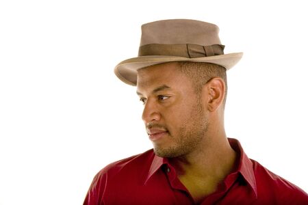 A black man in a red shirt and a brown hat looking off to the rightの写真素材