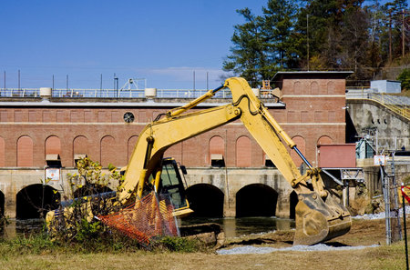 Heavy Construction Equipment in front of a Hydroelectric dam