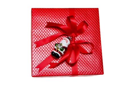 A nicely wrapped Christmas gift in red with santa claus on white backgroundの写真素材
