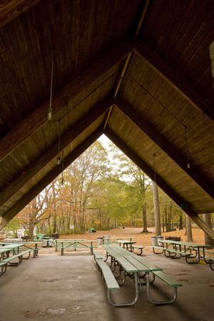 Picnic tables under a wood pavilion in a parkの写真素材