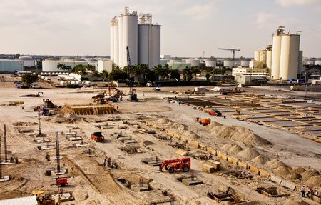 A large construction project coming out of the ground in an industrial areaの写真素材