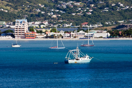 Boats anchored in the deep blue water of a caribbean bayの写真素材