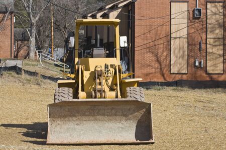 Heavy Construction Equipment by Old Apartment Buildingsの写真素材