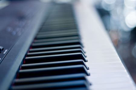 Closeup of a piano keyboard  focused on black keysの写真素材