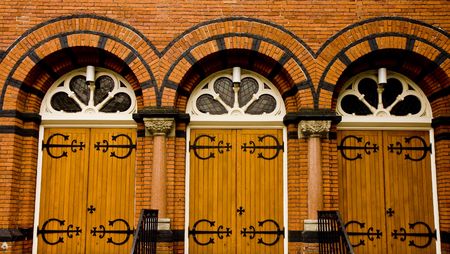 Three doors on an old church of wood planks and iron hardwareの写真素材