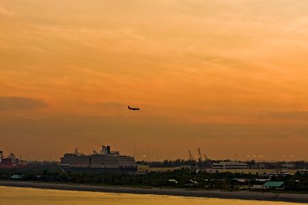 Cruise Ships at Sunset with airplane flying overheadの写真素材