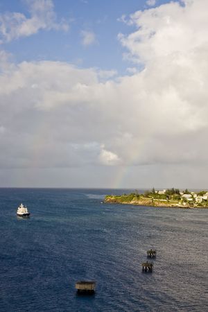 A white ferry boat passing pylons in the bayの写真素材