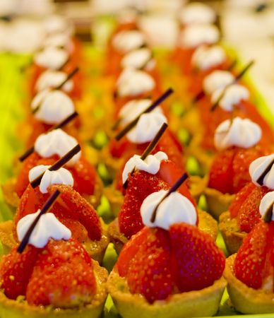 Fresh sweet strawberry tarts with whipped cream and chocolateの写真素材