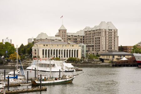 A harbor beside an old hotel and a museumの写真素材