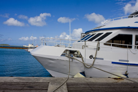Bow of a large white yacht tied up at a dockの写真素材