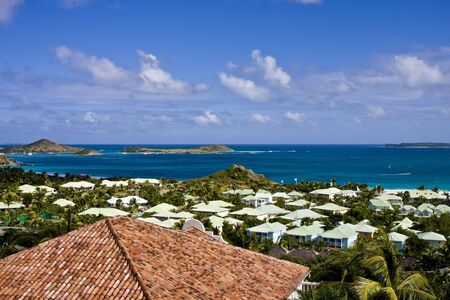 A coastal scene with cottages and bungalows along blue waterの写真素材
