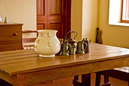 An early american interior with table, chest, and crockeryの写真素材