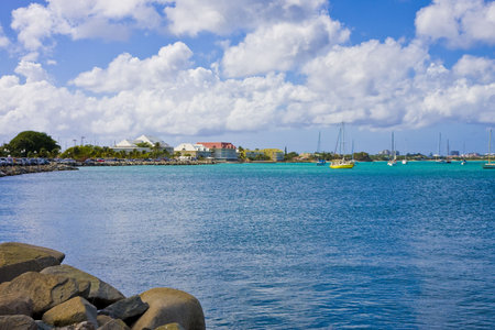 A bright yellow boat anchored in a deep blue bay