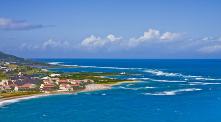 A point of a tropical island with red roofed villasの写真素材