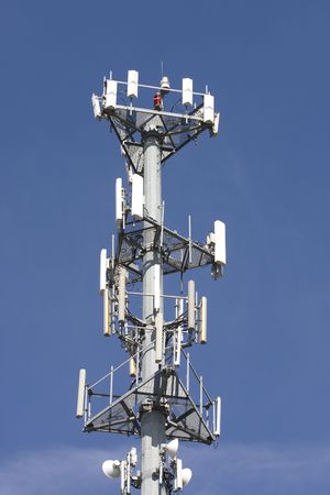 A cellular telephone tower against a blue skyの写真素材