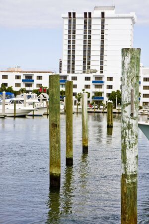 A white hotel next to a marinaの写真素材