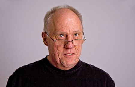 An older bald man in a black shirt looking happy
の写真素材
