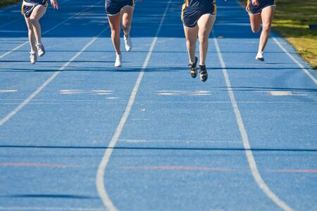 Legs of runners approaching the finish line of a raceの写真素材