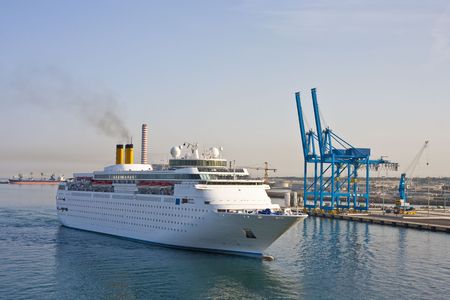 A Cruise Ship sailing into a port at dawnの写真素材