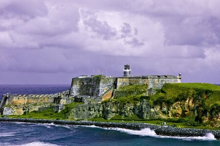 An old fort standing over the coast of an islandの写真素材