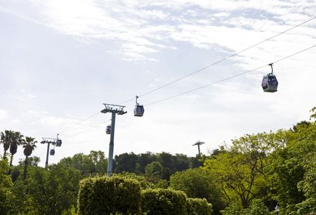Cable cars over Barcelona Spain Against a partly cloudy skyの写真素材