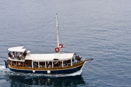 A boat full of tourists on an excursion in the Adriatic Seaの写真素材