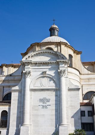 A massive old  church on the canal in Venice Italyの写真素材