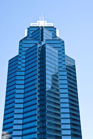 A window washer working on the side of a nice tall office building の写真素材