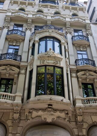 A beautiful spanish apartment building with lovely glass windowsの写真素材