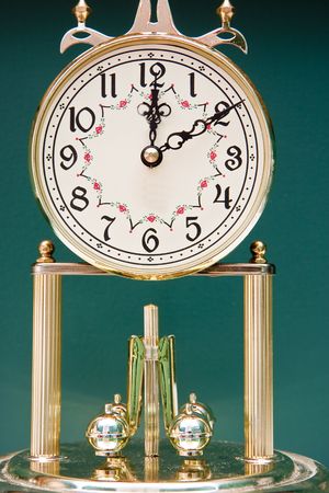 A classic anniversary clock against a green backgroundの写真素材