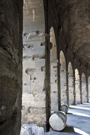 A row of columns and arches under the ancient Roman Coliseumの写真素材