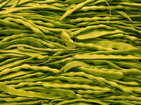 A bin of fresh green beans in a vegetable marketの写真素材