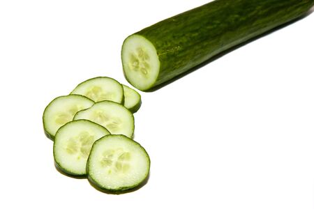 A cucumber and slices on a white backgroundの写真素材