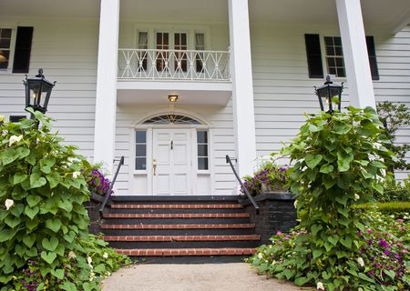 Brick Steps between gardens leading to colonial porchの写真素材