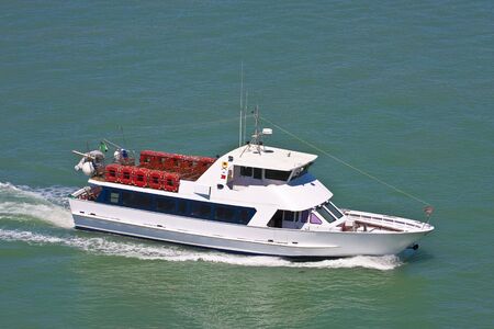 An empty sightseeing or tour boat in calm green waterの写真素材