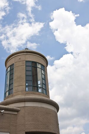 An office tower against a partly cloudy skyの写真素材