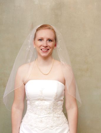 The bride smiling and radiant in her white wedding gownの写真素材