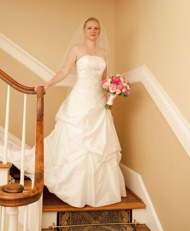 A beautiful young bride in her wedding gown with bouquetの写真素材