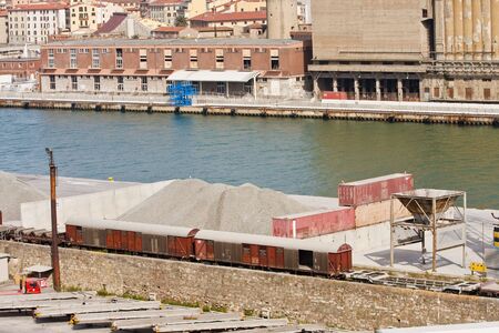 Gravel piles at an industrial port and canalの写真素材