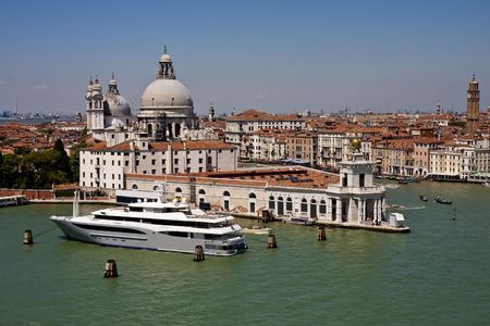 A view of the beautiful architecture, churches, and boats along the canals in Venice, Italyの写真素材