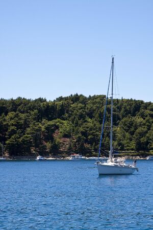 Boats in the brilliant blue bay of the Adriatic sea in Croatiaの写真素材