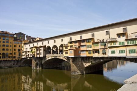 A view of the bridge ponte vecchio across the arno river in florence italyの写真素材